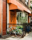 Bike and house with orange door in Greenpoint, Brooklyn, New York City Royalty Free Stock Photo