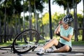 Bike injuries. Woman cyclist fell off road bike while cycling. Bicycle accident, injured elbow