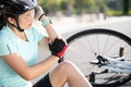Bike injuries. Woman cyclist fell off road bike while cycling. Bicycle accident, injured elbow