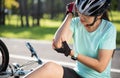 Bike injuries. Woman cyclist fell off road bike while cycling. Bicycle accident, injured back Royalty Free Stock Photo