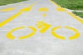 Bike lane with painted yellow bicycle sign and arrow near pedestrian crossing, closeup Royalty Free Stock Photo