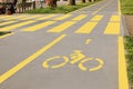 Bike lane with painted yellow bicycle sign and pedestrian crossing outdoors Royalty Free Stock Photo