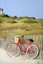 Bike leaning against fence at beach. Royalty Free Stock Photo