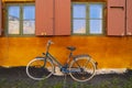 Bike leaning against the orange wall Royalty Free Stock Photo