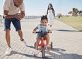 Bike, learning and child with family at beach or city park for growth development, support and motivation of mother and Royalty Free Stock Photo