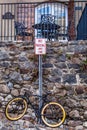 A bike locked up to a sign post.