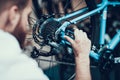 Bike Mechanic Repairs Bicycle in Workshop