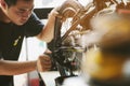 Bike mechanic repairs folding bicycle in Workshop. adjust Rear Derailleur ,Maintenance and repair concept Royalty Free Stock Photo