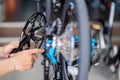 Bike mechanic repairs folding bicycle in Workshop. install Crankset Chainring,  Bicycle Maintenance and Repair concept Royalty Free Stock Photo