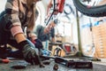 Bike mechanic working on a bicycle getting her tools