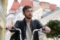 Bike messenger sits on bicycle and looks around Royalty Free Stock Photo