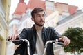 Bike messenger with backpack sits on bicycle and looks around Royalty Free Stock Photo