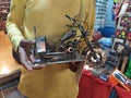 Bike mini model at hands of a seller in Indian shop.