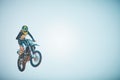 Bike, motorcycle and jump on blue sky mockup for speed challenge, sports and fearless risk. Driver, air stunt and Royalty Free Stock Photo