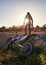 Bike, off road sports and man with helmet on track at sunset for competition, race or training. Challenge, fitness and Royalty Free Stock Photo