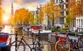 Bike over canal Amsterdam city autumn yellow leaf fall. Royalty Free Stock Photo
