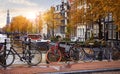 Bike over canal Amsterdam city autumn yellow leaf fall Royalty Free Stock Photo