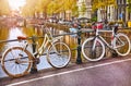 Bike over canal Amsterdam city. Picturesque town landscape in Netherlands with view on river Amstel.