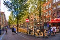 Bike over canal Amsterdam city. Picturesque town landscape with people and old buildings facade in Netherlands with vi Royalty Free Stock Photo