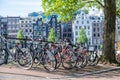 Bike parked on a canal bridge. Amsterdam traditional faÃÂ§ade house background, Netherlands Holland Royalty Free Stock Photo