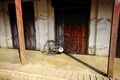 The bike parked at the old wooden door. Royalty Free Stock Photo