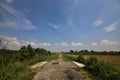 Bike path on an enbankment in the middle of the fields in the italian countryside in summer Royalty Free Stock Photo