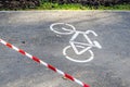 bike path fenced with red and white protective tape. Fenced area in park, prohibition of movement Royalty Free Stock Photo