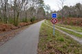 Bike path sign road in forest cycling in autumn Royalty Free Stock Photo