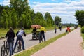 Bike hire, people ride their bikes along the waterfront