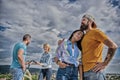 Bike rental service concept. Get bicycle for girlfriend. Couple with bicycle having great time while another couple Royalty Free Stock Photo