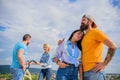 Bike rental service concept. Get bicycle for girlfriend. Couple with bicycle having great time while another couple Royalty Free Stock Photo