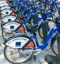Bike rental station with many blue and white bikes in the city of Rennes in Brittany in France