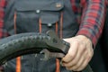 bike repair. Bike mechanic in the workshop. A mechanic holds tools and a bicycle wheel in his hand. Hands of the master and keys Royalty Free Stock Photo