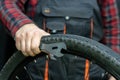 bike repair. Bike mechanic in the workshop. A mechanic holds tools and a bicycle wheel in his hand. Hands of the master and keys Royalty Free Stock Photo