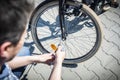Bike repair. The man tightens the screw at the brakes with the key Royalty Free Stock Photo