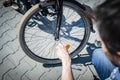 Bike repair. The man tightens the screw at the brakes with the key Royalty Free Stock Photo