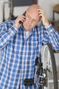 bike repairman speaking on smartphone Royalty Free Stock Photo