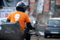 bike rider with helmet and a swiggy tshirt showing the rapid growth of food delivery e-commerce startups unicorns