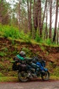 Bike Rider Relaxing on Motorcycle in Tree Forest in Himalayas