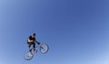 Bike rider tricking while jumping during bikes competition