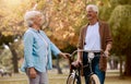 Bike, senior couple and ride outdoor for health, wellness, loving and bicycle. Retirement, love and mature man with Royalty Free Stock Photo