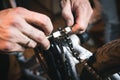 Bike service: mechanic serviceman repairman installing assembling or adjusting bicycle gear on wheel in workshop Royalty Free Stock Photo