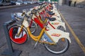 Bike sharing service racks in Milan. The yellow Bikemi bicycles are availabe for rental with the public transport ticket, Italy Royalty Free Stock Photo