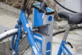 Modern blue bikes at city rental station Royalty Free Stock Photo