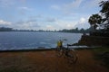 Bike standing in front of the lake in the Angkor Park, it`s raining.