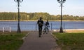 Bike at the summer sunset on the tiled road in the city park. Cycle closeup wheel on blurred summer background. Bicycle and Royalty Free Stock Photo