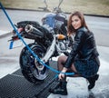 A bike are taking care by beauty attractive girl in carwash