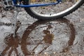 Bike Tire and Kickstand in Puddle with Raindrops.