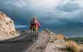 Bike tourist rides on Himalaya mountain road on way to buddist m