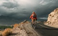 Bike tourist rides on Himalaya mountain road on way to buddist monastery